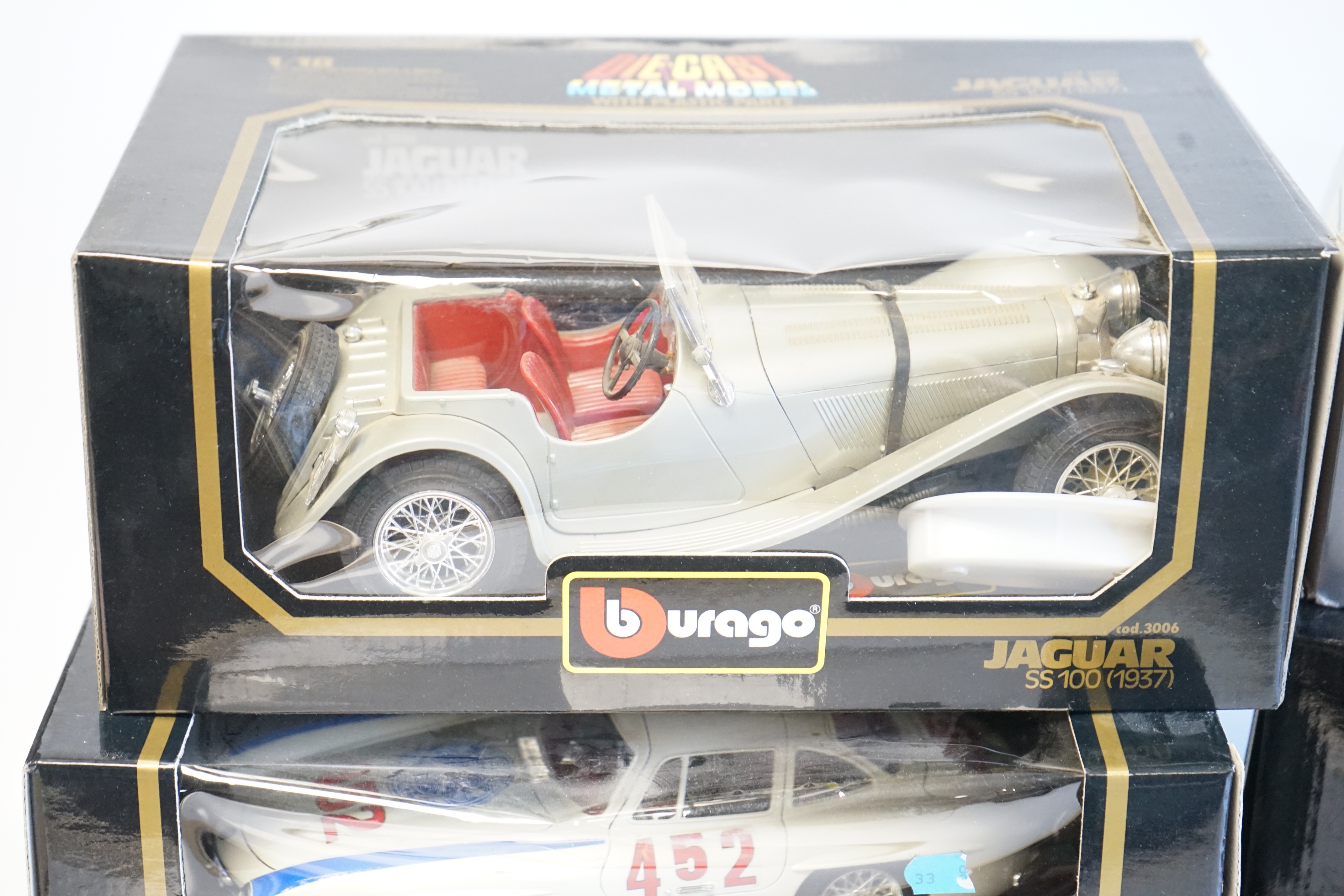 Six boxed Burago Diecast racing cars, five in 1/18 scale including; a Mercedes-Benz SSK, a Mercedes-Benz 300SL, a Jaguar SS100, a Lancia Aurelia B24 spider and an Alfa Romeo 2300 spider, together with a 1/24 scale Ford A